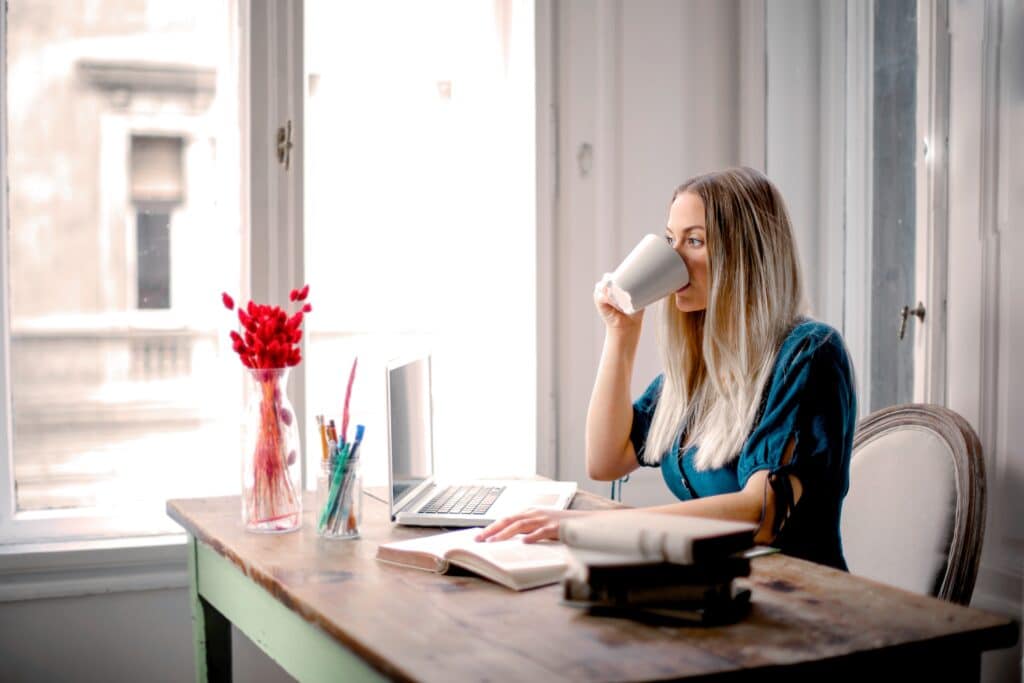 Despondent woman working from home staring into the distance thinking about quitting job