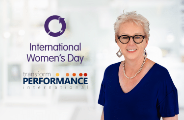 Photo of Amanda Street with two company logos, one of Transform Performance International logo, the other International Women's Day logo